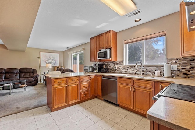 5001 E Killdeer Ct, West Richland, WA 99353 - kitchen with appliances with stainless steel finishes, a sink, a peninsula, open floor plan, and brown cabinetry