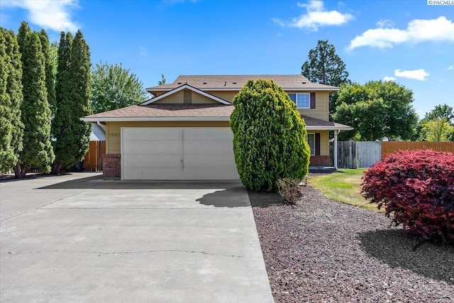 5001 E Killdeer Ct, West Richland, WA 99353 - obstructed view of property featuring brick siding, driveway, and a garage