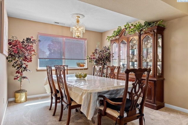 5001 E Killdeer Ct, West Richland, WA 99353 - dining space with light colored carpet, baseboards, and a chandelier