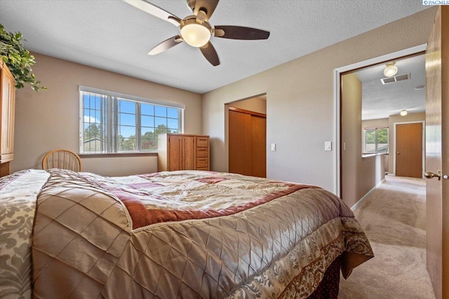 5001 E Killdeer Ct, West Richland, WA 99353 - carpeted bedroom with a ceiling fan, a closet, and a textured ceiling