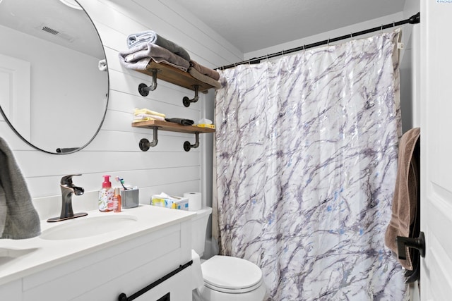 bathroom with walk in shower, vanity, toilet, and wood walls