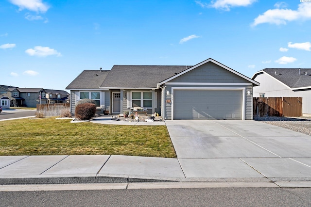 view of front of house featuring a garage and a front lawn