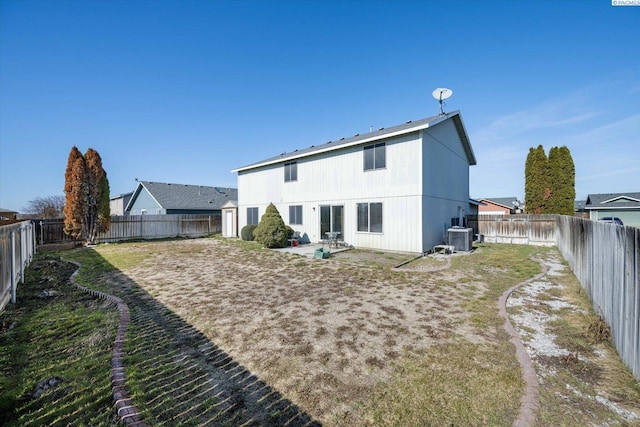 rear view of property with central air condition unit and a fenced backyard