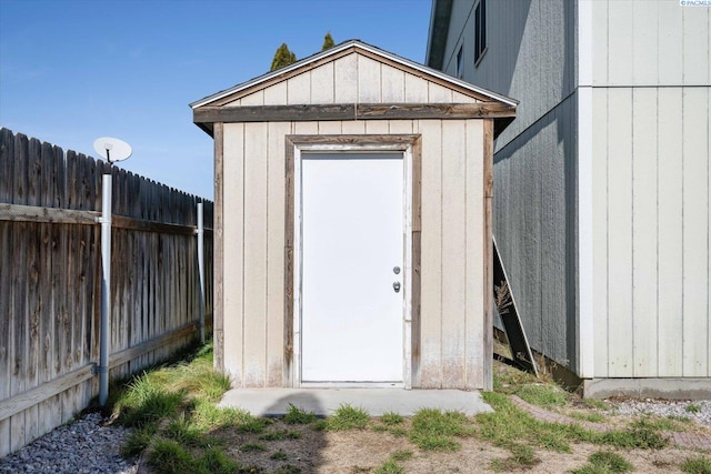 view of shed featuring fence