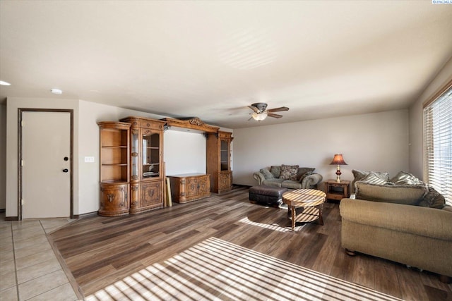 living area featuring a ceiling fan and wood finished floors