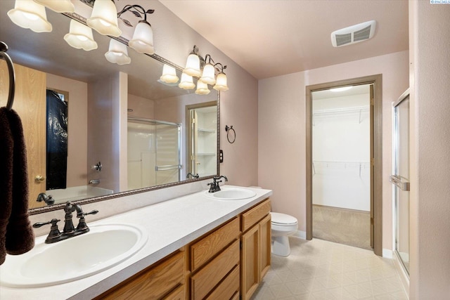 full bath with double vanity, a shower stall, visible vents, and a sink