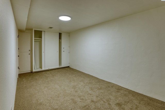 unfurnished bedroom with light carpet and a closet