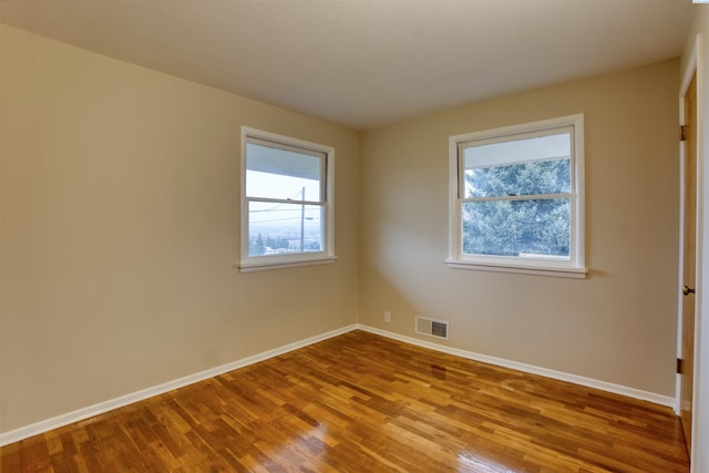 spare room with light hardwood / wood-style floors