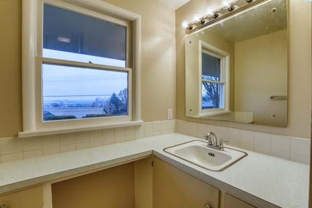 bathroom featuring vanity and decorative backsplash