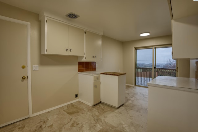 kitchen with white cabinetry and decorative backsplash