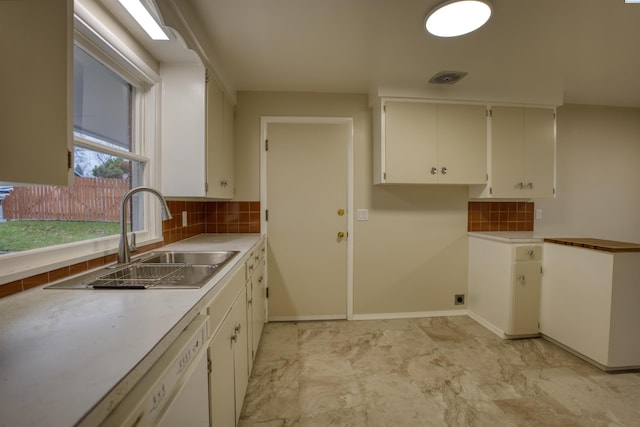 kitchen featuring white cabinetry, sink, decorative backsplash, and white dishwasher