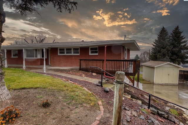 single story home with a storage shed and a patio