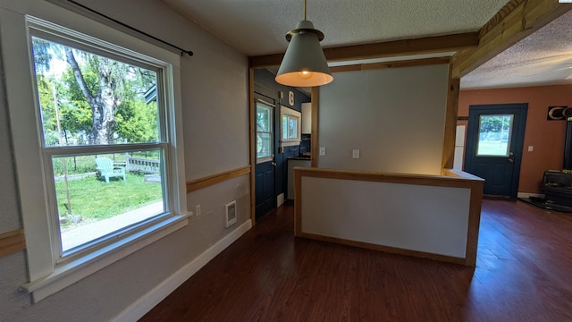 535 SE Side St, Pullman, WA 99163 - unfurnished dining area with a textured ceiling, dark wood-style flooring, and baseboards