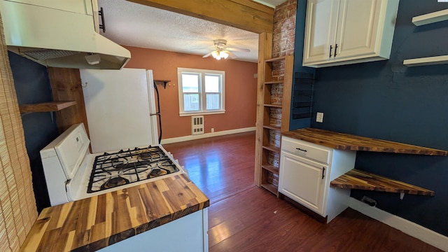 535 SE Side St, Pullman, WA 99163 - kitchen with butcher block counters, white appliances, under cabinet range hood, open shelves, and a textured ceiling
