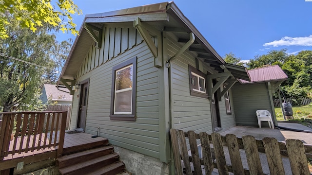 535 SE Side St, Pullman, WA 99163 - view of home's exterior featuring a wooden deck, board and batten siding, and a patio area