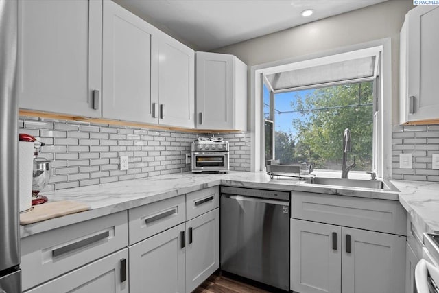 506 Hedrick Pl, Grandview, WA 98930 - kitchen with dishwasher, a sink, tasteful backsplash, white cabinetry, and light stone countertops