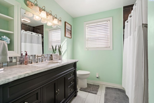 1907 Howell Ave, Richland, WA 99353 - full bath with baseboards, a wealth of natural light, toilet, and vanity
