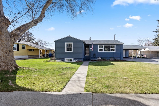 1907 Howell Ave, Richland, WA 99353 - view of front of home with driveway, a carport, roof with shingles, and a front lawn