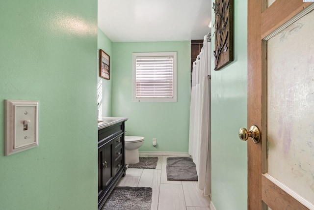 1907 Howell Ave, Richland, WA 99353 - bathroom featuring toilet, vanity, and baseboards