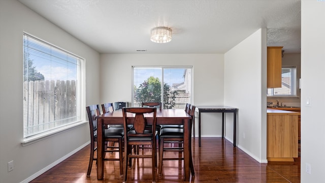 9907 Chelan Ct, Pasco, WA 99301 - dining area featuring dark wood-style floors, plenty of natural light, a chandelier, and a textured ceiling