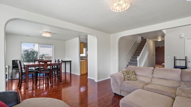 9907 Chelan Ct, Pasco, WA 99301 - living area with dark wood finished floors, arched walkways, stairway, and a chandelier