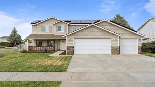 9907 Chelan Ct, Pasco, WA 99301 - view of front of property featuring a porch, a front yard, concrete driveway, an attached garage, and stone siding