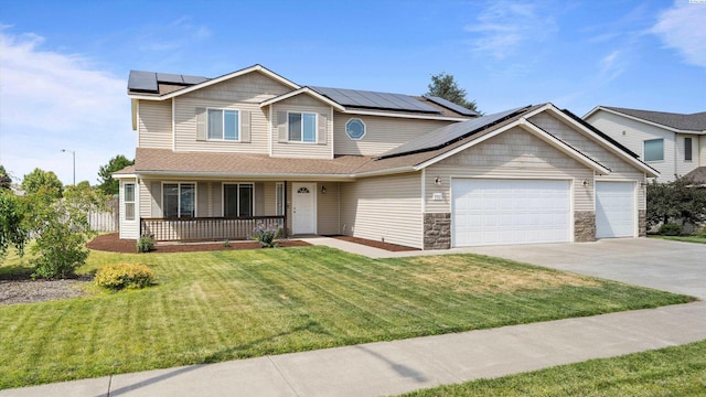 9907 Chelan Ct, Pasco, WA 99301 - view of front of house with covered porch, solar panels, an attached garage, a front lawn, and concrete driveway