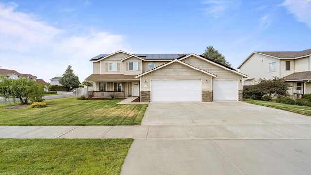 9907 Chelan Ct, Pasco, WA 99301 - view of front facade with a garage, a porch, a front yard, driveway, and solar panels