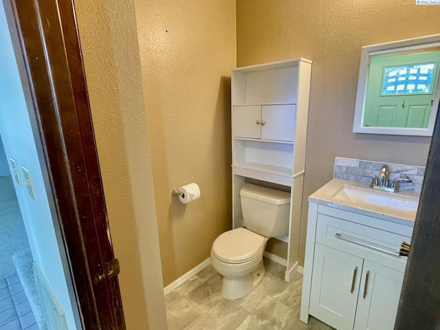 2120 Duportail St Unit 1, Richland, WA 99352 - half bath with toilet, vanity, a textured wall, and baseboards