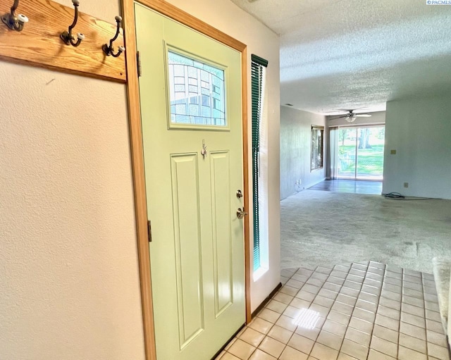2120 Duportail St Unit 1, Richland, WA 99352 - entryway featuring light carpet, a textured ceiling, light tile patterned floors, and ceiling fan