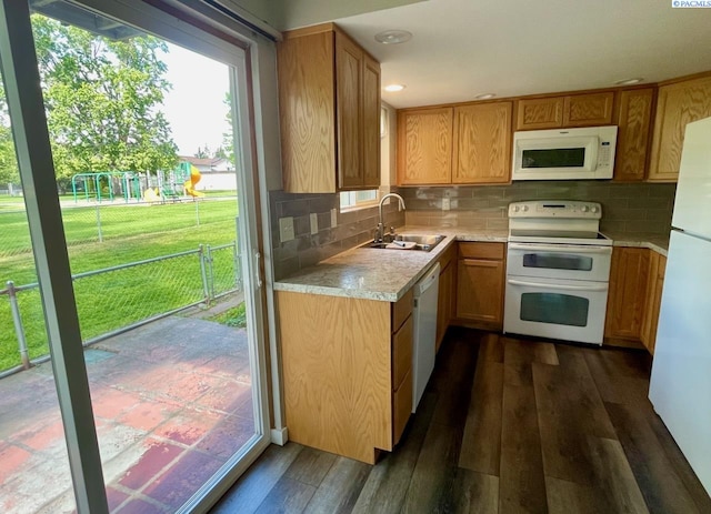 2120 Duportail St Unit 1, Richland, WA 99352 - kitchen featuring white appliances, a sink, light countertops, dark wood-type flooring, and backsplash