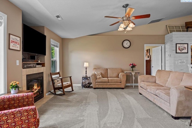 8602 W 1st Ave, Kennewick, WA 99336 - carpeted living room with a ceiling fan, a tile fireplace, baseboards, and lofted ceiling