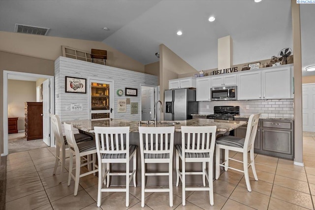 8602 W 1st Ave, Kennewick, WA 99336 - kitchen featuring appliances with stainless steel finishes, a sink, light tile patterned floors, white cabinets, and backsplash
