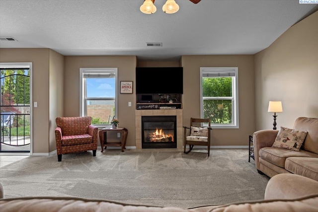 8602 W 1st Ave, Kennewick, WA 99336 - carpeted living room with a tiled fireplace and baseboards