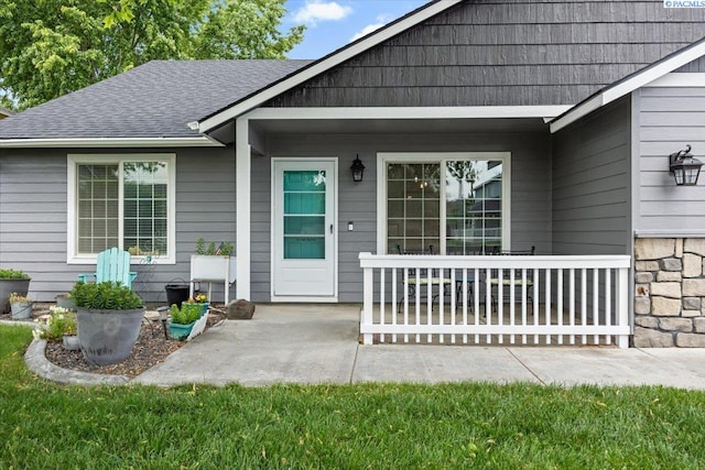 8602 W 1st Ave, Kennewick, WA 99336 - doorway to property featuring roof with shingles and a patio