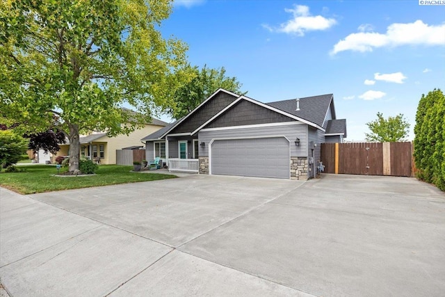 8602 W 1st Ave, Kennewick, WA 99336 - view of front of home featuring a garage, stone siding, and concrete driveway