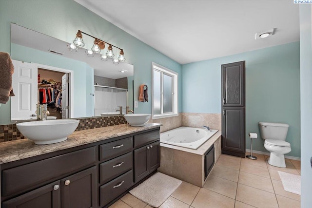 8602 W 1st Ave, Kennewick, WA 99336 - full bathroom with a shower stall, tile patterned flooring, double vanity, a garden tub, and toilet