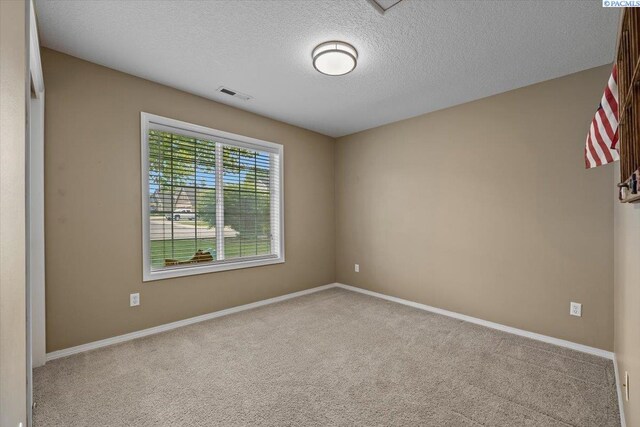 8602 W 1st Ave, Kennewick, WA 99336 - spare room featuring carpet flooring, a textured ceiling, and baseboards