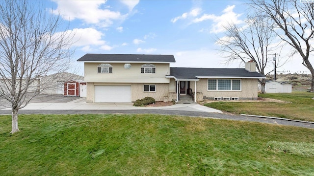 split level home with a garage and a front yard