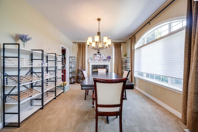 1105 SW Meyer Dr, Pullman, WA 99163 - carpeted dining area with a chandelier, plenty of natural light, and a high end fireplace