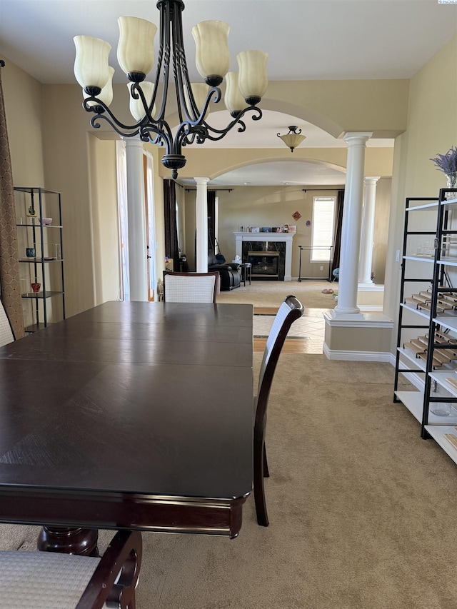 1105 SW Meyer Dr, Pullman, WA 99163 - dining room with ornate columns, carpet floors, a glass covered fireplace, and arched walkways