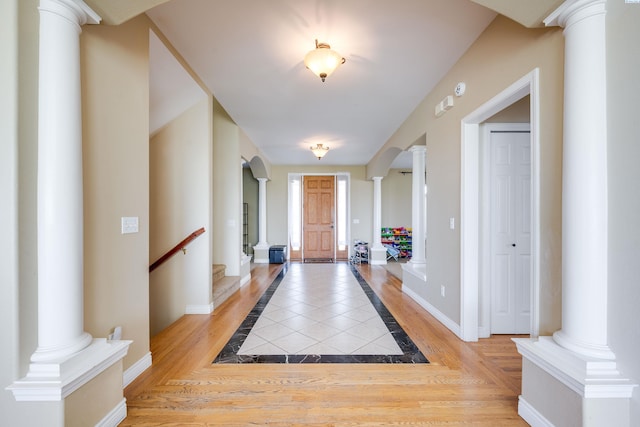 1105 SW Meyer Dr, Pullman, WA 99163 - foyer entrance featuring ornate columns, inlaid floor details, and stairway