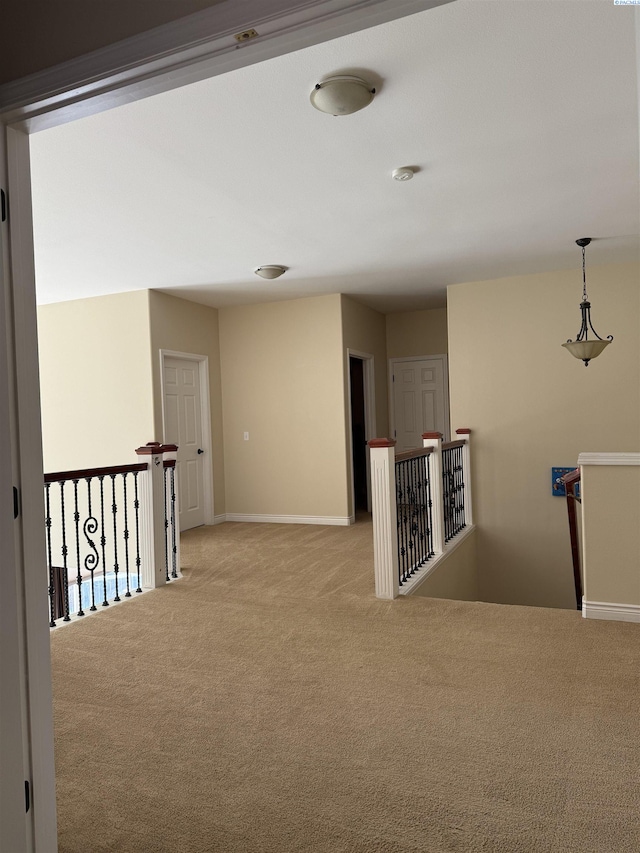 1105 SW Meyer Dr, Pullman, WA 99163 - hallway with light carpet, an upstairs landing, and baseboards