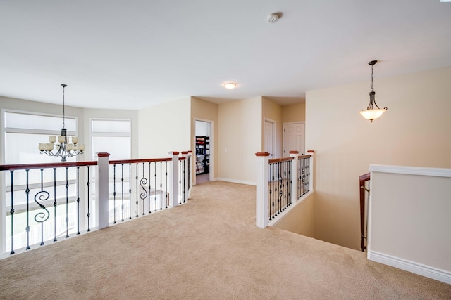 1105 SW Meyer Dr, Pullman, WA 99163 - hall featuring carpet flooring, an upstairs landing, and a chandelier