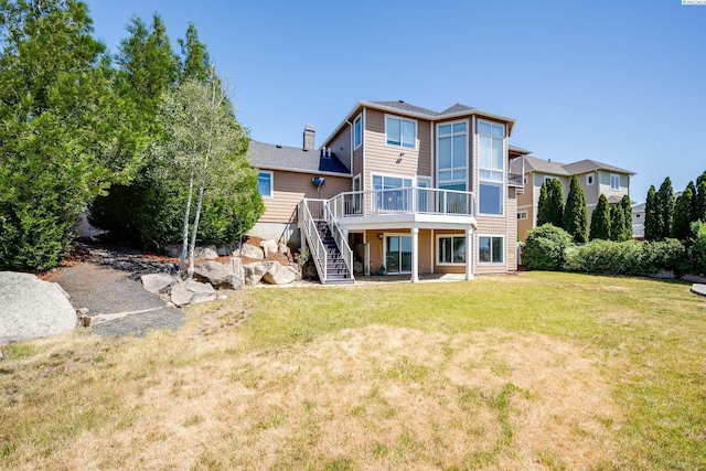 1105 SW Meyer Dr, Pullman, WA 99163 - rear view of house with stairs, a deck, and a lawn