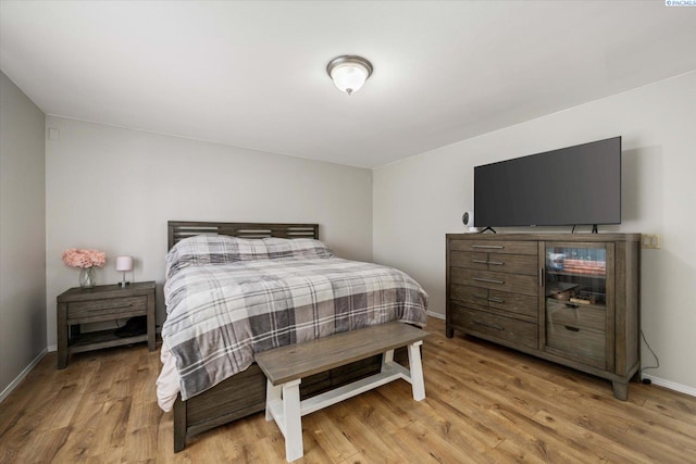 bedroom with baseboards and light wood-style floors