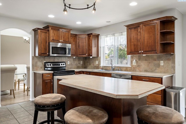 kitchen featuring a breakfast bar, stainless steel appliances, and light countertops