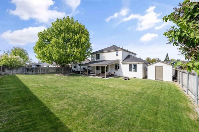 rear view of house with a patio, a fenced backyard, a lawn, and a storage shed