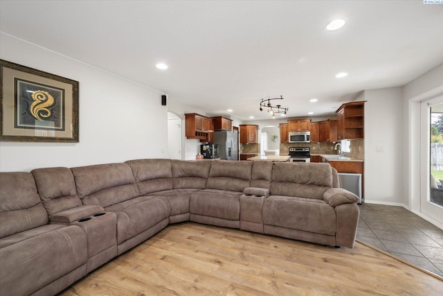 living area with recessed lighting, arched walkways, and light tile patterned floors