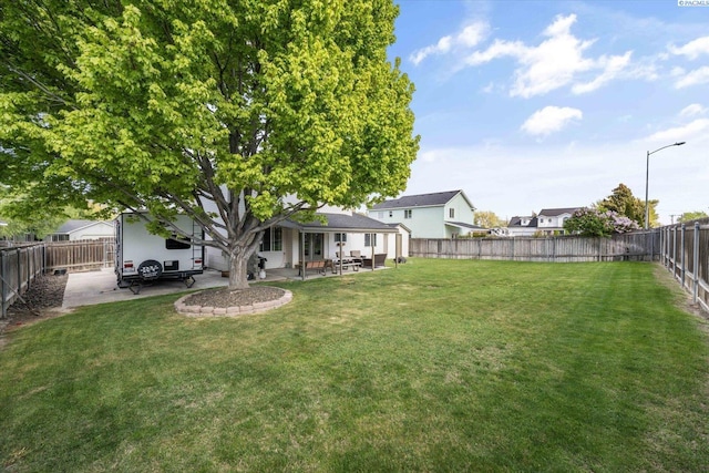 view of yard featuring a patio and a fenced backyard